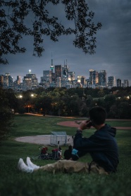 帅哥坐在草地上观看夜景图片