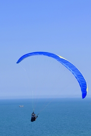 海平面上高空滑翔伞运动图片