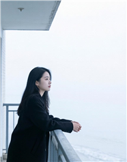 黑色大衣美女阳台瞭望远方图片